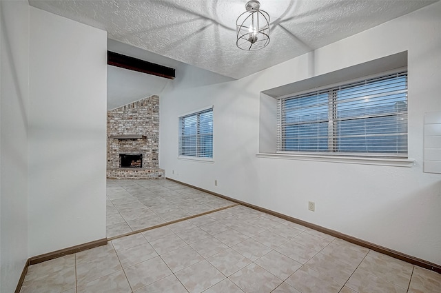 unfurnished living room featuring vaulted ceiling with beams, a chandelier, a textured ceiling, a fireplace, and light tile patterned floors