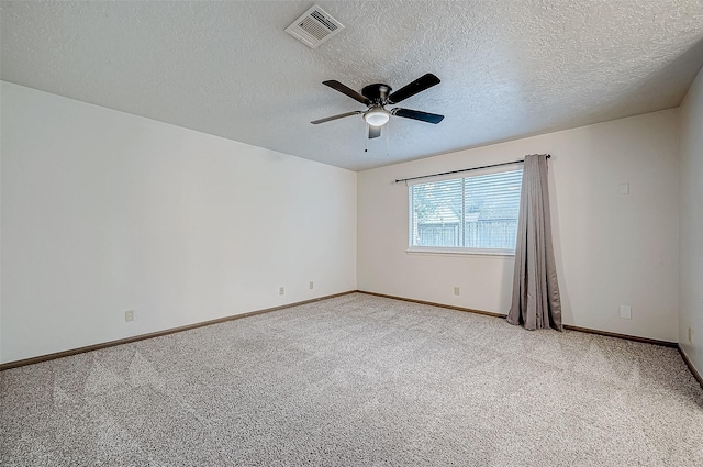 carpeted spare room with ceiling fan and a textured ceiling