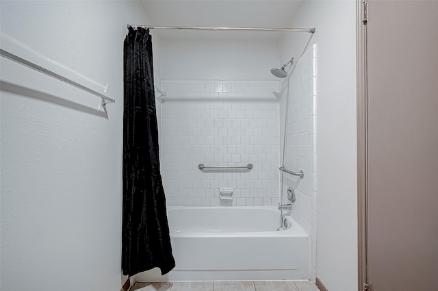 bathroom with tile patterned floors and shower / bath combo with shower curtain