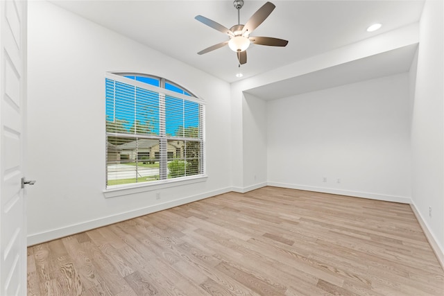 unfurnished room with ceiling fan and light wood-type flooring