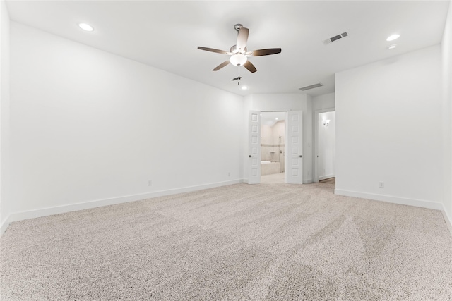 carpeted spare room featuring ceiling fan