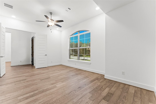 empty room featuring ceiling fan and light wood-type flooring