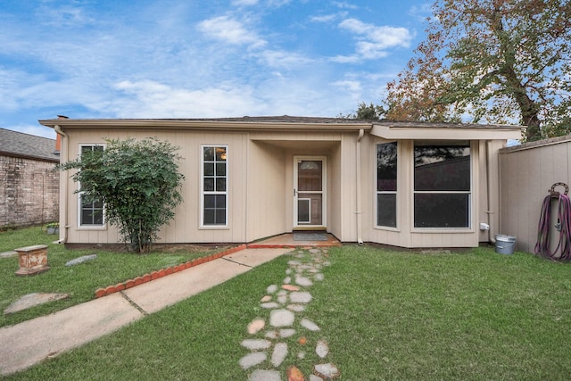 rear view of property with a yard