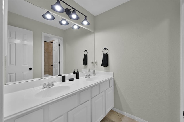 bathroom featuring tile patterned flooring, vanity, and walk in shower