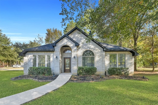 view of front of property with brick siding and a front yard