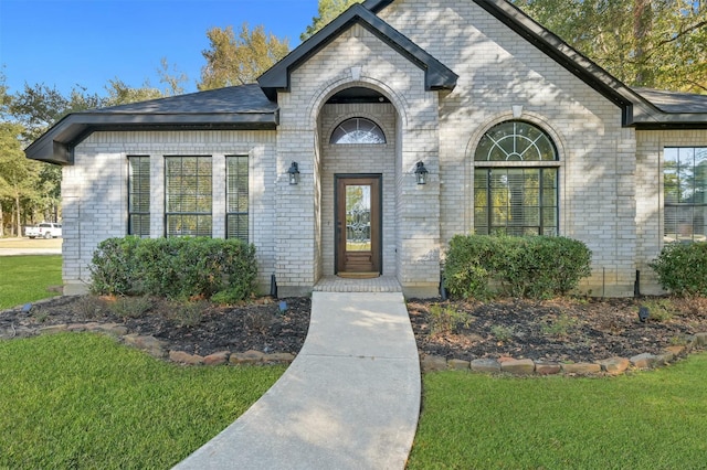 doorway to property with a yard