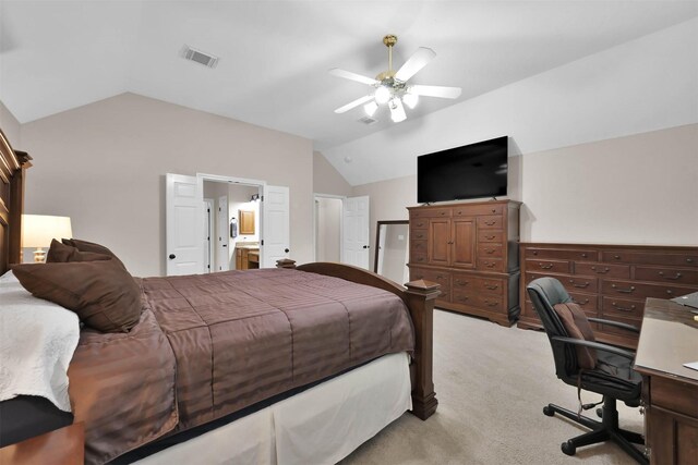 bedroom featuring ensuite bath, ceiling fan, light colored carpet, and lofted ceiling