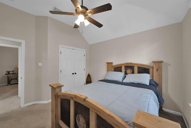 carpeted bedroom featuring ceiling fan, a closet, and high vaulted ceiling