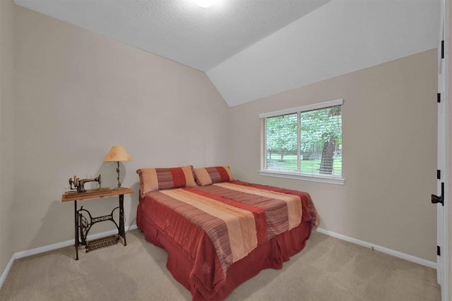 carpeted bedroom with lofted ceiling and a textured ceiling