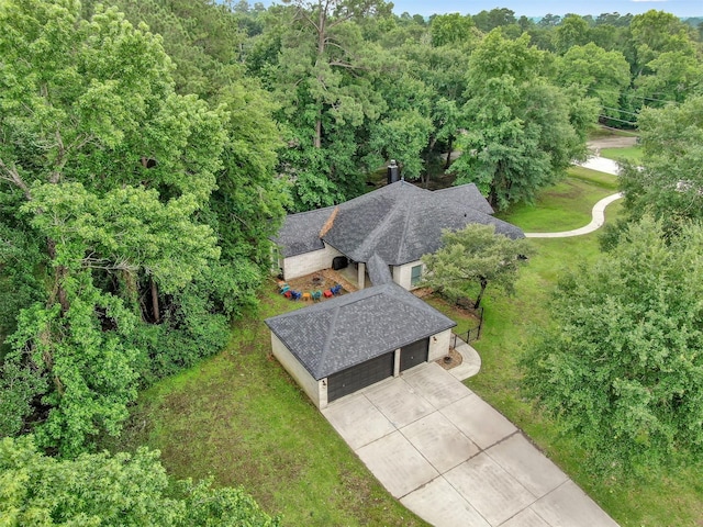 birds eye view of property with a forest view