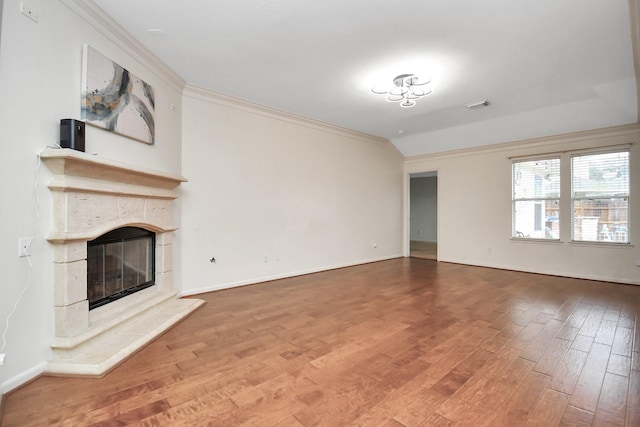 unfurnished living room with ornamental molding, lofted ceiling, and hardwood / wood-style flooring