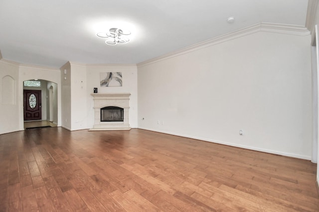 unfurnished living room with hardwood / wood-style flooring and crown molding