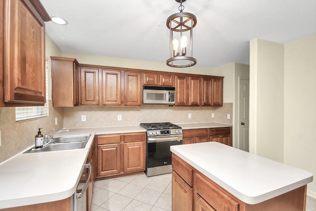 kitchen featuring stainless steel appliances, sink, pendant lighting, light tile patterned floors, and a center island