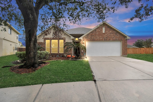 single story home with a lawn and a garage