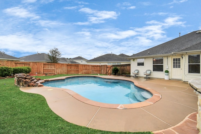 view of swimming pool with a yard and a patio