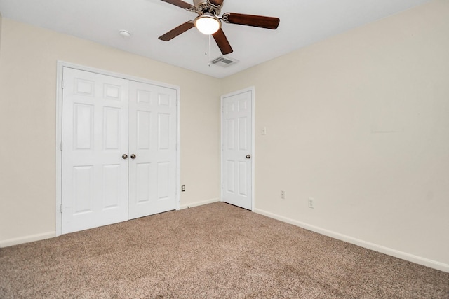 unfurnished bedroom featuring carpet floors, a closet, and ceiling fan