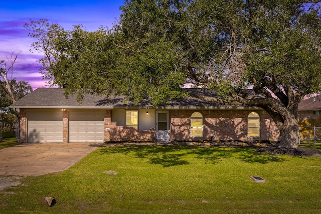 view of front of home with a lawn and a garage