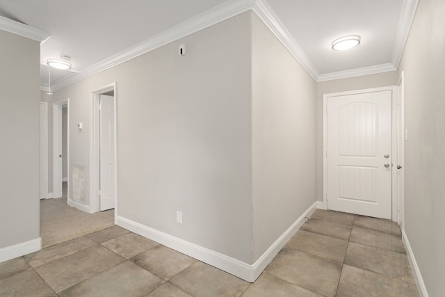 corridor with tile patterned floors and crown molding