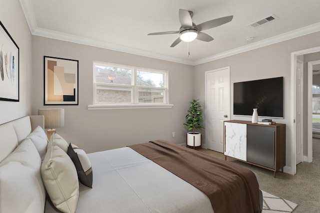 carpeted bedroom featuring ceiling fan and crown molding