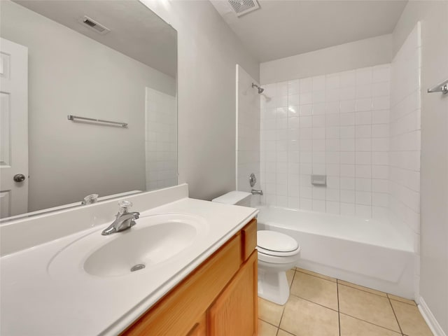 full bathroom with tile patterned flooring, vanity, tiled shower / bath combo, and toilet