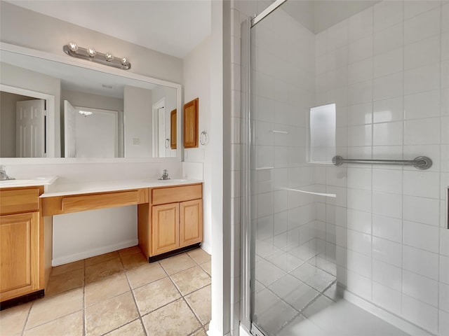 bathroom featuring tile patterned flooring, vanity, and a shower with door