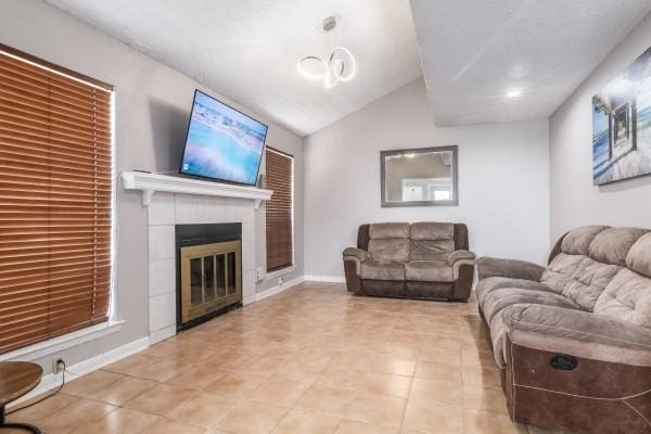 tiled living room with a fireplace and vaulted ceiling