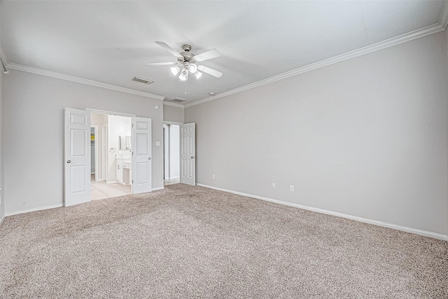 unfurnished bedroom featuring ceiling fan, ensuite bathroom, light carpet, and ornamental molding