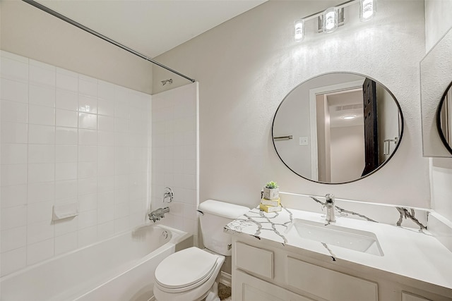 full bathroom featuring toilet, vanity, and tiled shower / bath