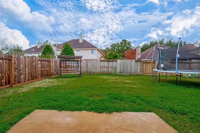 view of yard featuring a patio and a trampoline