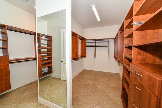 spacious closet featuring light tile patterned floors