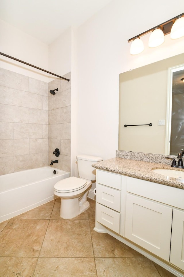 full bathroom featuring tile patterned flooring, vanity, toilet, and tiled shower / bath combo