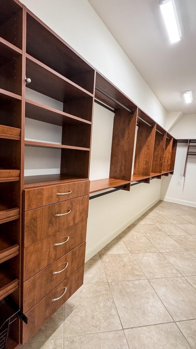 spacious closet with light tile patterned flooring