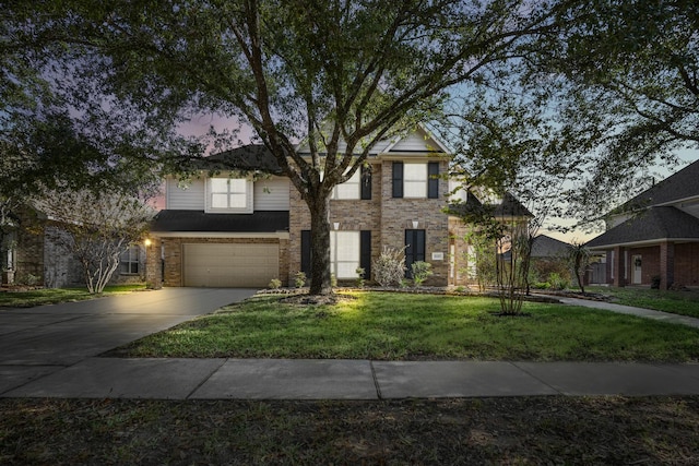 view of front of property with a yard and a garage