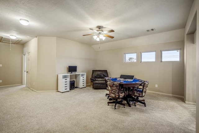 carpeted dining room with ceiling fan, a textured ceiling, and vaulted ceiling