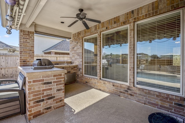 view of patio with area for grilling, ceiling fan, and exterior kitchen