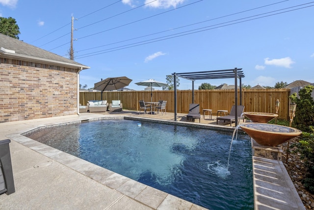 view of swimming pool featuring pool water feature, outdoor lounge area, and a patio