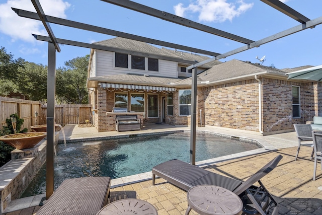 view of swimming pool with pool water feature and a patio area