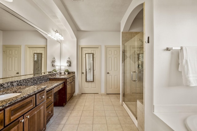 bathroom with tile patterned flooring, vanity, and shower with separate bathtub