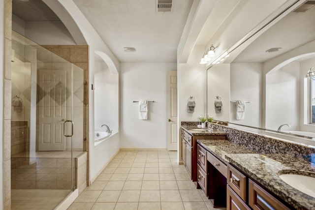 bathroom featuring tile patterned floors, vanity, and shower with separate bathtub