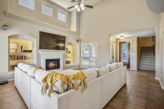 living room featuring tile patterned flooring, a towering ceiling, and ceiling fan