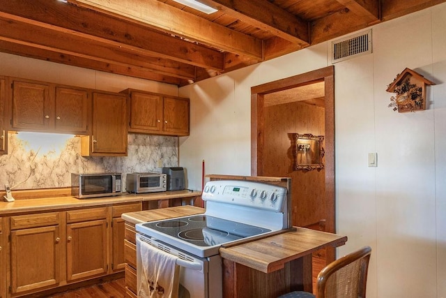 kitchen featuring beam ceiling, butcher block counters, dark hardwood / wood-style flooring, electric stove, and decorative backsplash