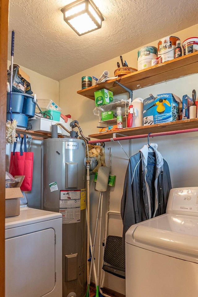 laundry room with separate washer and dryer, electric water heater, and a textured ceiling