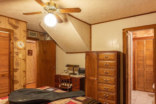 tiled bedroom with a textured ceiling, ceiling fan, ornamental molding, and wood walls