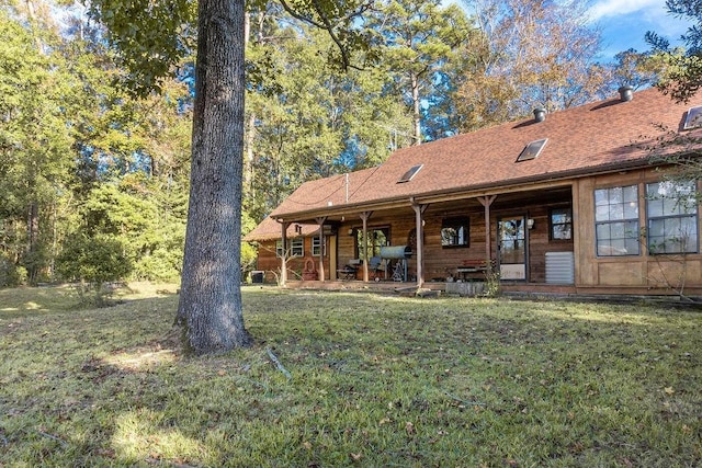 rear view of house with a lawn