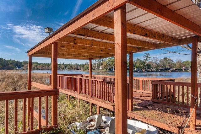 wooden terrace featuring a water view