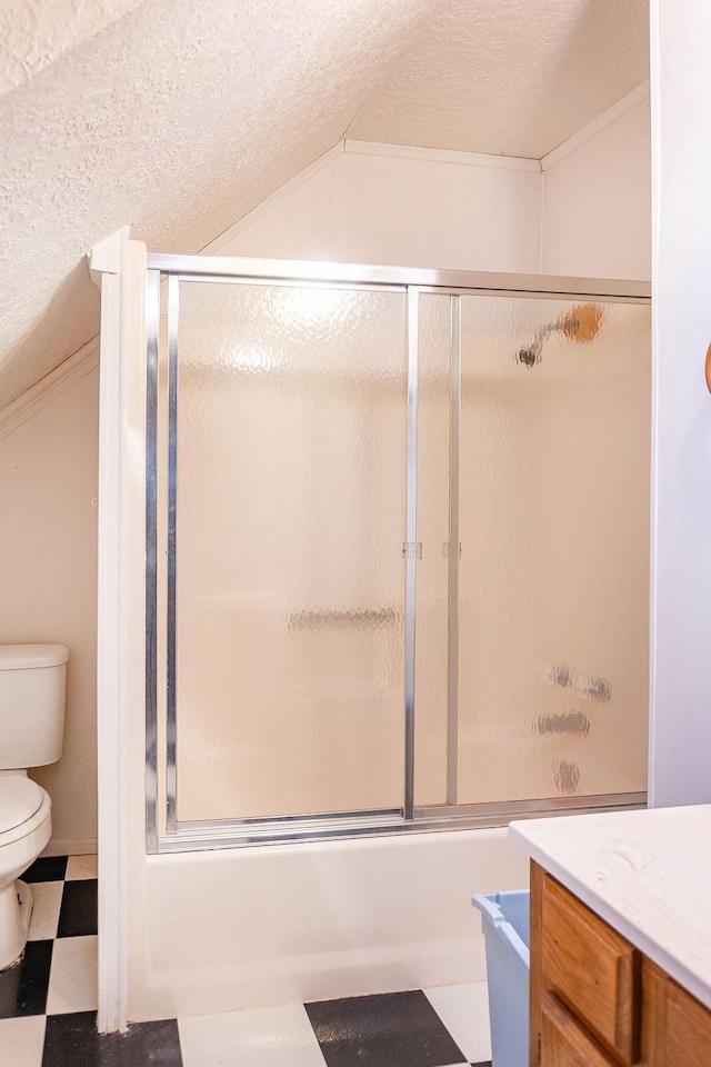 full bathroom featuring a textured ceiling, vanity, toilet, and enclosed tub / shower combo