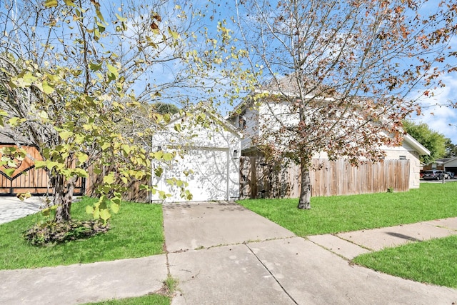 view of front of house with a front yard and a garage