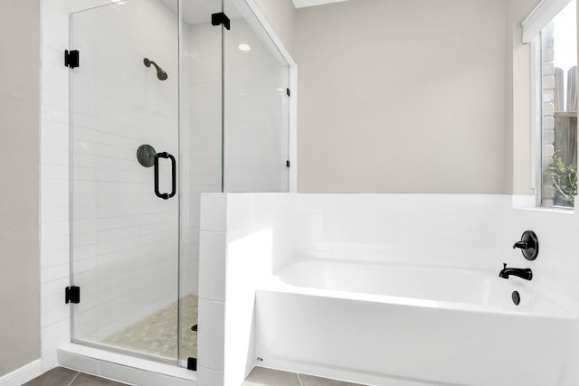 bathroom featuring tile patterned flooring and independent shower and bath