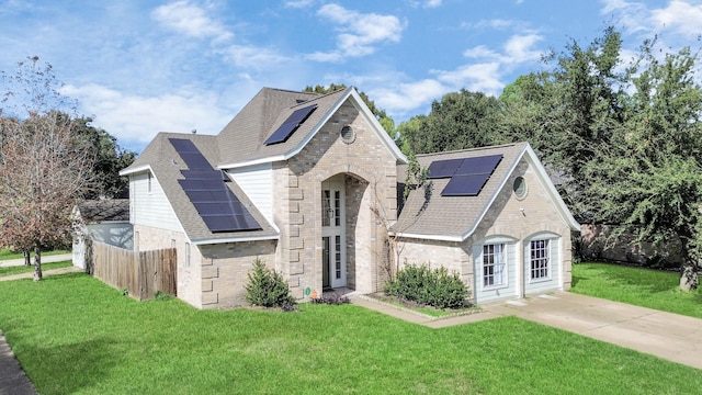 view of front of house featuring a front yard and solar panels