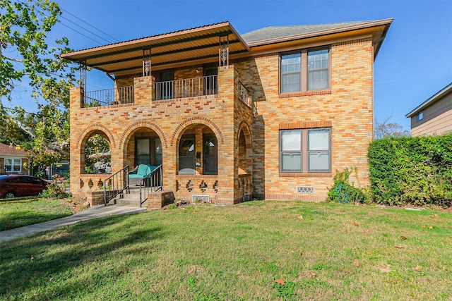 view of front facade with a front yard, a balcony, and covered porch